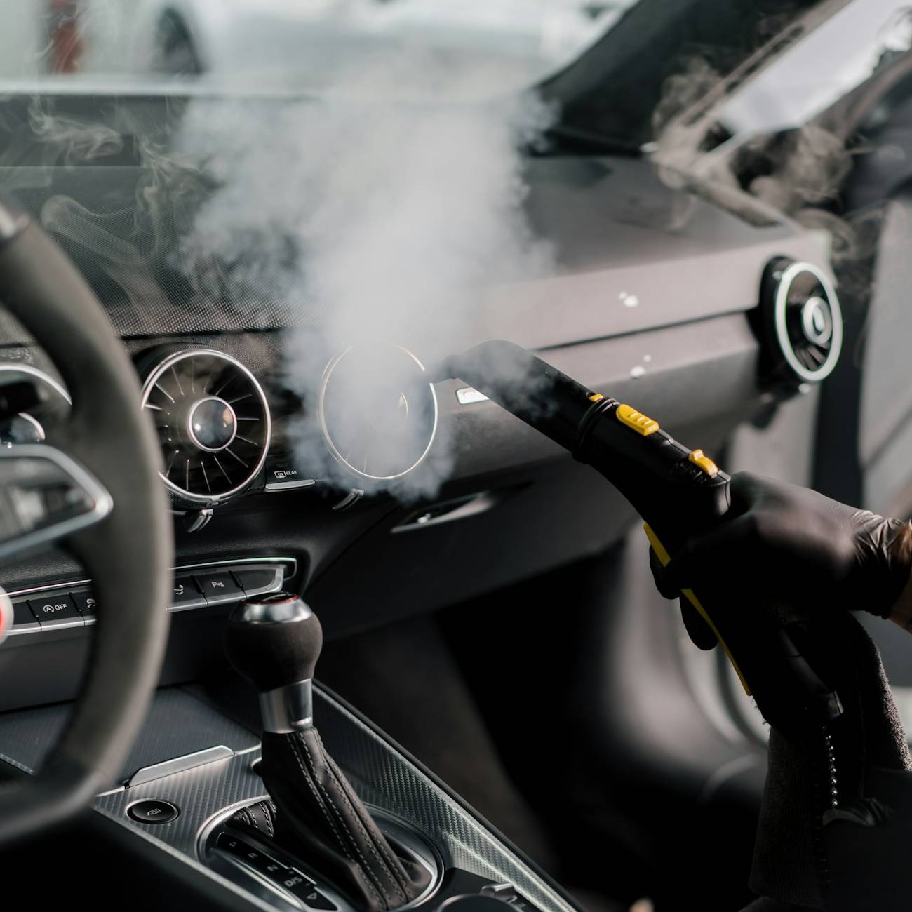 the-detailing-master-cleans-the-car-interior-with-a-hot-steam-cleaner-cleaning-the-car-interior-e1708875465128